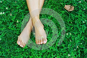 Feet resting on grass photo