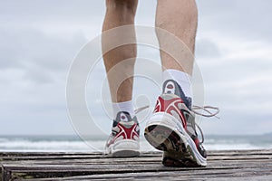 Feet of runner on a beach