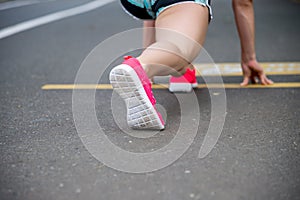 Feet running on road closeup on shoe