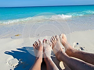 Feet in the sand at Playa Blanca, Cayo Largo, Cuba