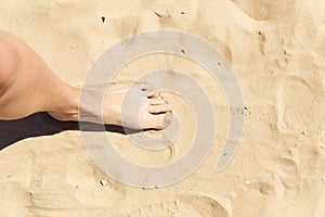 Feet in the sand. Summer vacation concept