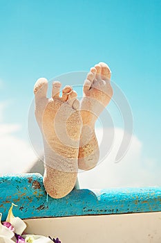 Feet in the sand. Wedding rings