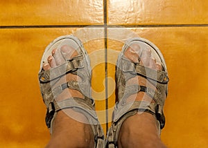 Feet in sandals with sand