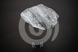 Feet selfie on black sand beach with diamond ice blocks, Iceland