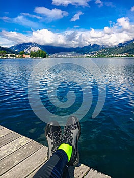 Feet Selfie Traveler relaxing with lake and mountains view on background Lifestyle hiking Travel concept summer
