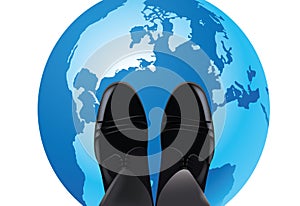 Feet with shiny shoes above globe- photo