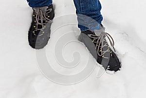 Feet in shoes in the white snow