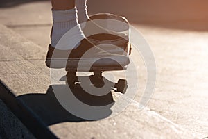 Feet on a skateboard.