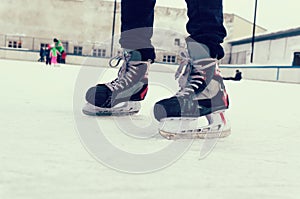 feet on the skates of a person rolling on the ice rink