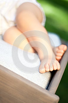 Feet of a small child on a blanket close-up