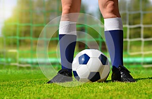 Feet of soccer player with ball.