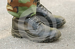 Feet of soldier in military boots anduniform