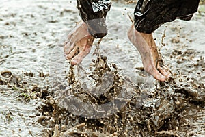 Feet splashing in muddy water