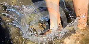 Feet splashing water. photo