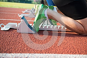 Feet on starting block ready for a spring start.