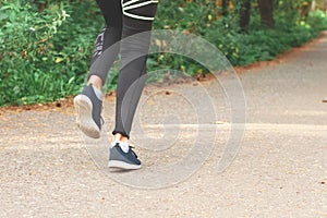 Feet step runner on the road, closeup shoes. Start running on the sidelines. Run outdoor exercise activity concept.