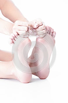 Feet Therapy Concepts. Closeup Image of Soft and Beautiful Female Foot While Hands Touching Toes And Massaging Placed Over Pure