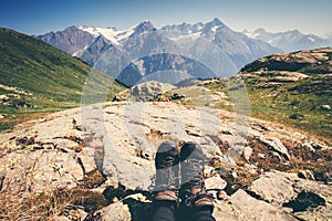 Feet trekking boots hiker with mountains landscape outdoor