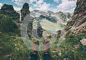 Feet trekking boots and mountains landscape on background Travel Lifestyle adventure