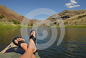 Feet up while relaxing during leisure time on a kayak