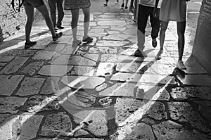 Feet walking on travertine floor in the Colosseum in Rome