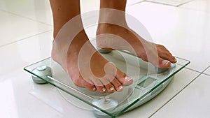 Feet of woman on weighting scale