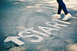 Feet of women with start word on road