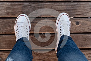 Feet on a wooden plank surface