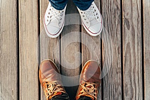 Feet on a wooden plank surface