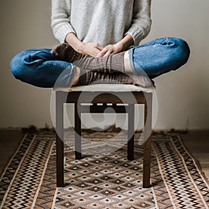 Feet in woollen socks. Woman is relaxing with a cup of hot drink and warming up her feet in woollen socks.