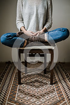 Feet in woollen socks. Woman is relaxing with a cup of hot drink and warming up her feet in woollen socks.