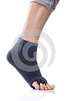 Feet with yoga toe separator socks on white background