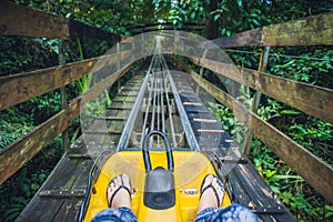 Feet of a young woman on Alpine Coaster