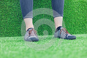 Feet of young woman on astro turf photo