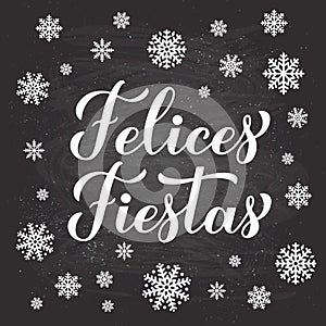 Felices Fiestas calligraphy hand lettering on chalkboard background with snowflakes. Happy Holidays in Spanish