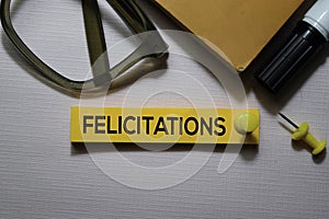 Felicitations text on sticky notes isolated on office desk photo