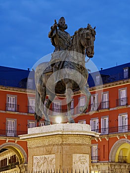 Felipe III Statue in plaza mayor in Madrid at dawn or twilight perspective view photo