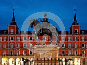 Felipe III Statue in plaza mayor in Madrid at dawn or twilight side view photo