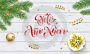 Feliz Ano Nuevo Spanish Happy New Year golden decoration and calligraphy font on white wooden background for greeting card. Vector photo