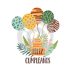 Feliz cumpleanos jungle cake. Feliz Cumpleanos means Happy Birthday in Spanish. Tropical birthday cake candle, balloons, jungle photo