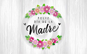 Feliz dia de la Madre inscriptions on wooden boards and branch of flowers photo