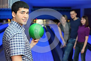 Fellow holds ball for bowling friends hearten him