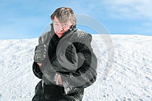Fellow stands in winter holds brief-case