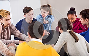 Fellow students playing Mafia game at recess