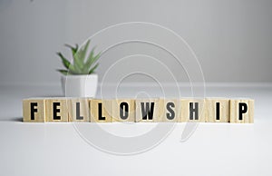 Fellowship concept - Fellowship word on wooden cubes