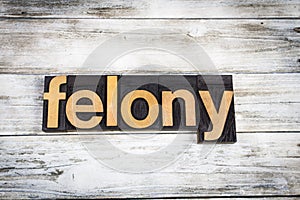 Felony Letterpress Word on Wooden Background