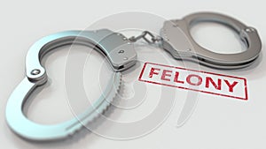 FELONY stamp and handcuffs. Crime and punishment related conceptual 3D rendering
