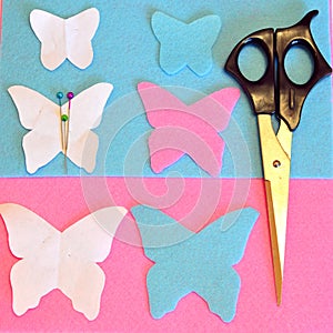 Felt butterfly, scissors, pins, paper patterns. Sewing set