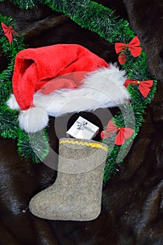 Felt christmas stocking, a christmas hat, a green garland