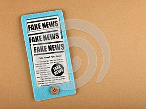 Felt craft smartphone with FAKE NEWS newspapers